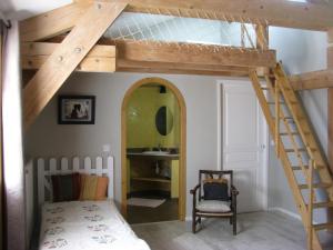 a loft bed with a ladder in a bedroom at Le Péché de Paresse in Saint-André-en-Vivarais