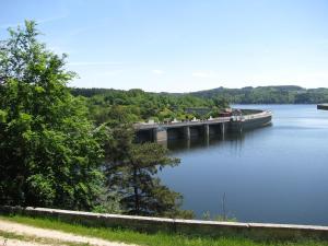 a bridge over a body of water with trees at Le Péché de Paresse in Saint-André-en-Vivarais