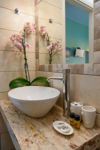 a bathroom with a white bowl sink on a counter at Avra in Agia Galini