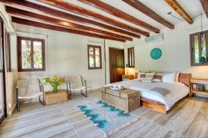 a bedroom with a bed and a table and chairs at Tulum Luxury Collection in Tulum