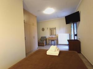 A bed or beds in a room at Queen of Orliaka