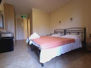 A bed or beds in a room at Queen of Orliaka