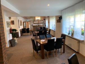 a dining room with tables and chairs in a restaurant at Landhotel & Restaurant "Fahrenkamp" in Röwitz