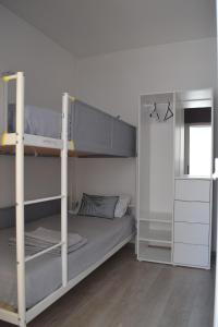 a bedroom with two bunk beds and a window at Casa Amado in Lagos