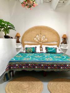 a bedroom with a large bed and two rugs at Casa Carmela, rural house with spectacular views, in an exquisite area in Atalbéitar