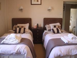 two beds in a room with towels on them at Lily Hill Farm in Barnard Castle