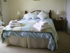 a bedroom with a bed with towels on it at Lily Hill Farm in Barnard Castle