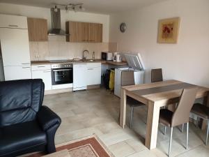a kitchen with a wooden table and a dining room at Angelhof Weseloh Appartement in Bruchhausen-Vilsen