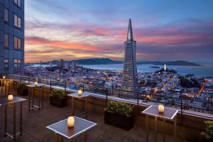 a view of a city skyline at night with tables at Four Seasons Hotel San Francisco at Embarcadero in San Francisco