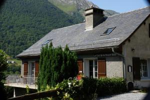 a house with a mountain in the background at Le Clot de la Hount in Cauterets