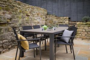 a table and chairs sitting on a patio at Locksbrook Lodge - Hot Tub - Spacious Outdoor Space in Bath