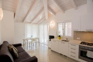 a kitchen and living room with a couch and a table at Appartamenti Laly in Arco