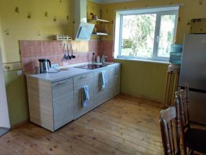 A kitchen or kitchenette at Viesu nams Purenes