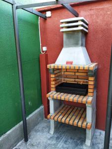 a brick oven sitting next to a green wall at Casa Dana in Santiago de Compostela