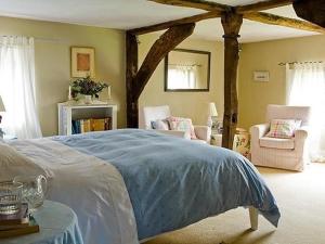 a bedroom with a large bed with a blue blanket at The Old Manor House B & B in Brasted +10 photos
