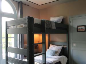 two bunk beds in a room with a window at La mare aux bambous in Couffy