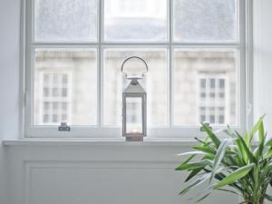 a lantern sitting on a window sill next to a plant at Marischal Apartments in Aberdeen
