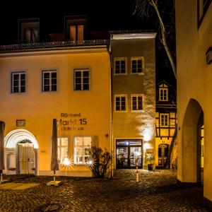 a group of buildings in a street at night at Markt 15 Gästehaus in Senftenberg