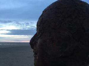 a large rock sitting on top of a beach at The Marlborough Hotel in Liverpool