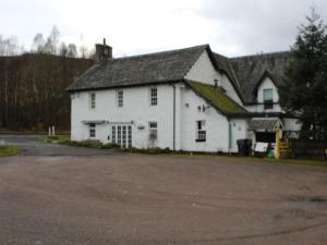 a large white building with a black roof at Luib Hotel in Killin