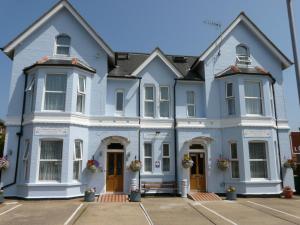 a large house with blue paint at Victoria Lodge in Sandown