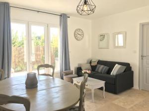a living room with a table and a couch at Les Mazets et Spa D'Uzes in Arpaillargues-et-Aureillac