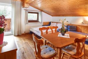 a bedroom with a bed and a table and chairs at Haus Obermühle in Maria Alm am Steinernen Meer
