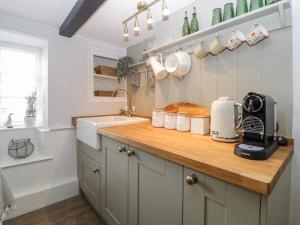a kitchen with a sink and a counter with a appliance at Clover Cottage in Plymouth +29 photos