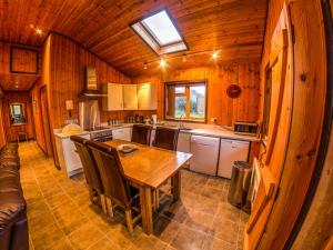 eine Küche mit einem Tisch und Stühlen in einer Hütte in der Unterkunft New Forest Lodges in Cranborne