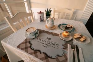 a table with a cup of coffee and a plate of food at Ca' Del Conte in Padula