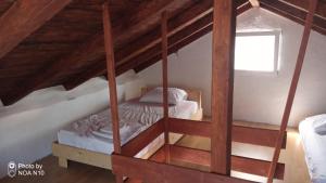 a bedroom with two bunk beds in a attic at Isolated, 30m to sea, Viktoria s cottage in Kali