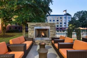 a fire pit with couches and a fireplace at Hyatt House - Charlotte Airport in Charlotte