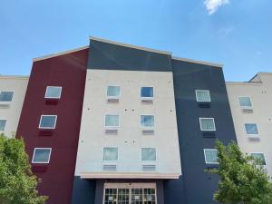 a building with a red white and blue at Candlewood Suites La Porte, an IHG Hotel in La Porte