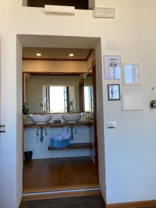 a bathroom with two sinks and a mirror at Palazzo Bolasco in Alghero