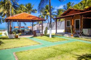 a villa with a view of the ocean at Parque dos Coqueiros- Bangalos e Suites in Maragogi