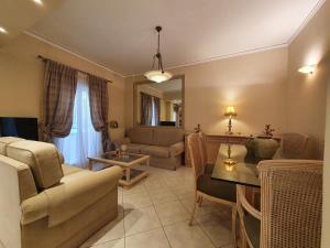 a living room with a couch and a table at Family Cozy Apartment in Heraklio