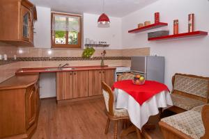 a kitchen with a table with a red table cloth on it at Diviš73 in Loket