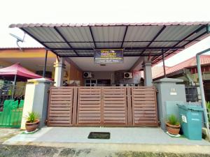 a wooden gate in front of a building at Umai homestay in Bandar  Pusat Jengka