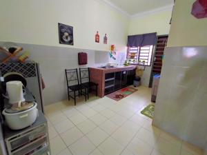a kitchen with a sink and a counter top at Umai homestay in Bandar  Pusat Jengka +9 photos