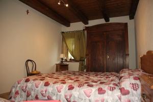 sypialnia z łóżkiem i drewnianymi drzwiami w obiekcie Il Sogno di Remí w mieście Brossasco