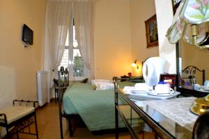 a living room with a bed and a table with chairs at Tucci's Roma Guest House in Rome