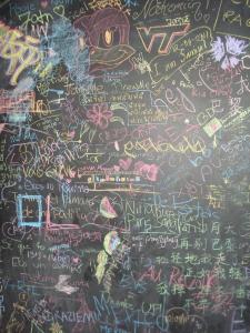 a wall covered in graffiti with writing on it at Le Montclair Montmartre by River in Paris