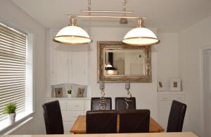 a dining room with a table and a mirror at Havendene in Haworth