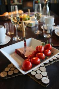 a plate of food with tomatoes on a table at Luxus-Landhaus im Schwarzwald/Baiersbronn mit Pool in Baiersbronn