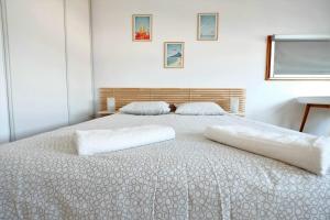 a bedroom with a bed with two pillows on it at Les Studiantes - T1 32 m² hypercentre gares/métro in Lille
