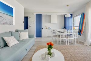 a blue and white living room with a couch and a table at Baltica SeaView by TriApart in Gdańsk