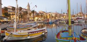 a group of boats docked in a harbor with buildings at Chambres d'hôtes Chez Pat et Nanou in Six-Fours-les-Plages