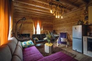 a living room with a couch and a refrigerator at The Meadow cabin in Žabljak