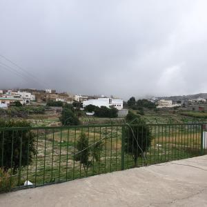 a black fence with a view of a city at منزل ريفي بناء حجري in Al Assan
