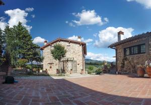 a large stone house with a brick driveway at Agriturismo Circugnano in Grassina